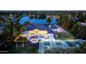 Expansive aerial view featuring luxury home with a pool, sports court, and beautiful landscaping near a tranquil lake at 5 E Oakwood Hills Dr, Chandler, AZ 85248