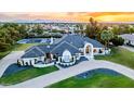 Wide aerial shot showcases a luxurious home with sports court, manicured landscaping, and a serene mountain backdrop at 5 E Oakwood Hills Dr, Chandler, AZ 85248