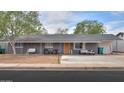 Charming single-story home featuring a cozy front porch with hanging swing and modern outdoor seating at 512 N Ironwood --, Mesa, AZ 85201