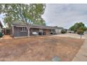 Charming single-story home featuring a cozy front porch with hanging swing and modern outdoor seating at 512 N Ironwood --, Mesa, AZ 85201