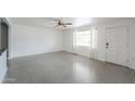Bright living room featuring polished concrete floors and a view of the front door and adjacent kitchen at 512 N Ironwood --, Mesa, AZ 85201
