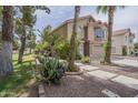 Charming two-story home featuring desert landscaping, mature trees, and a red tile roof at 533 N Cobblestone St, Gilbert, AZ 85234