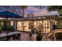 Charming brick backyard patio with outdoor dining, mature shade trees, and stylish lounge area at 5714 N 11Th St, Phoenix, AZ 85014