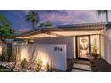 Close up front entrance with a walkway and cacti garden along a retaining wall at 5714 N 11Th St, Phoenix, AZ 85014