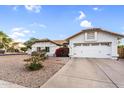 Charming single-story home features a two-car garage, gravel landscaping, and a new roof at 6145 E Snowdon St, Mesa, AZ 85215