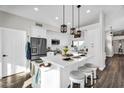 Bright kitchen with white cabinets, stainless steel appliances, and a large center island at 6145 E Snowdon St, Mesa, AZ 85215
