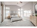 Bright bedroom boasts vaulted ceilings, neutral tones, multiple windows, and a stylish rug at 636 E Redondo Dr, Gilbert, AZ 85296