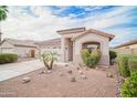 Beautifully landscaped home exterior with desert landscaping and a charming facade at 636 E Redondo Dr, Gilbert, AZ 85296