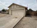 Detached garage with ample parking space and a driveway, offering convenient access at 6842 S 42Nd Pl, Phoenix, AZ 85042