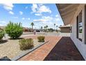 Landscaped front yard with brick-paved patio, mature bushes, and beautiful greenery enhances this home's curb appeal at 6923 E Hubbell St, Scottsdale, AZ 85257