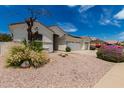 Single-story home featuring a three-car garage, desert landscaping, and drought-tolerant plants at 710 W Cherrywood Dr, Chandler, AZ 85248