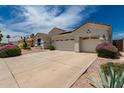 Inviting single-story home with desert landscaping, a three-car garage, and a large driveway at 710 W Cherrywood Dr, Chandler, AZ 85248