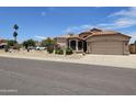 Charming home exterior with a well-maintained yard and a two-car garage at 7724 W Topeka W Dr, Glendale, AZ 85308