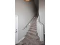 An interior shot of an empty staircase with natural wood planks and gray walls at 8180 E Shea Blvd # 1075, Scottsdale, AZ 85260