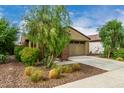 Attractive single-story home boasting a well-kept lawn and an attached two-car garage at 9222 W Roma Ave, Phoenix, AZ 85037