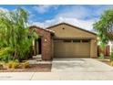 Inviting single-story home with a low-maintenance front yard and a two-car garage at 9222 W Roma Ave, Phoenix, AZ 85037