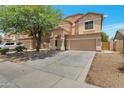 Charming two-story house showcasing a two-car garage, wide driveway, and well-maintained desert landscaping at 9948 W Chipman Rd, Tolleson, AZ 85353