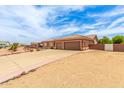 Spacious single-story house with three-car garage and gravel landscaping with mature trees at 10535 W San Miguel Ave, Glendale, AZ 85307