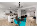 Open-concept living area showcasing a kitchen, dining space, and living room with modern furnishings at 10625 E Bramble Ave, Mesa, AZ 85208