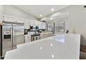 Bright kitchen features white cabinets, stainless steel appliances, and stone countertops at 11430 N 109Th St, Scottsdale, AZ 85259