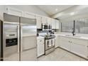 Bright kitchen features white cabinets, stainless steel appliances, and stone countertops at 11430 N 109Th St, Scottsdale, AZ 85259