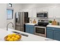 Modern kitchen features stainless steel appliances and white and blue cabinets at 11500 E Cochise Dr # 2001, Scottsdale, AZ 85259