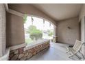 Inviting covered porch with stone accents, offering a relaxing outdoor space to enjoy the neighborhood views at 11563 W Jefferson St, Avondale, AZ 85323