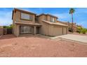 Charming two-story home boasts tile roof, three-car garage, and low-maintenance desert landscaping at 12325 W Canterbury Dr, El Mirage, AZ 85335