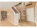 Home's foyer features high ceilings, neutral walls, tile floors and a staircase to the second floor at 12325 W Canterbury Dr, El Mirage, AZ 85335