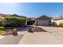 Charming single-story home with a well-manicured front yard and a two-car garage at 13629 W San Miguel Ave, Litchfield Park, AZ 85340