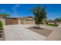 View of a single-story home with a driveway, mature landscaping, and two-car garage at 15038 N 22Nd St, Phoenix, AZ 85022