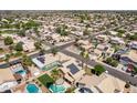 Detailed aerial view of neighborhood homes featuring pools, solar panels, and lush landscaping at 16071 W Sherman St, Goodyear, AZ 85338