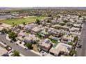 Expansive aerial view of a residential neighborhood, showcasing rooftops, streetscapes, and community baseball fields at 16071 W Sherman St, Goodyear, AZ 85338