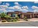 Charming single-story home featuring manicured landscaping, desert plants and a brick driveway at 16141 N 183Rd Dr, Surprise, AZ 85388