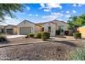Attractive home exterior featuring desert landscaping, a tile roof, and a welcoming front entrance at 16158 W Coronado Rd, Goodyear, AZ 85395