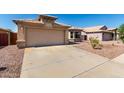 Lovely home showcasing a wide driveway, desert landscaping, and a convenient two-car garage at 1634 E Harwell Rd, Phoenix, AZ 85042