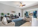 Bright living room with tile floors, neutral tones, and sliding glass doors to the backyard at 18577 W Coolidge St, Goodyear, AZ 85395