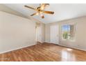 This open living room features wood flooring, a ceiling fan and a vaulted ceiling at 20428 N 32Nd Ln, Phoenix, AZ 85027