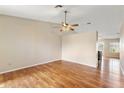 Open living area boasts beautiful laminate floors and a ceiling fan at 20428 N 32Nd Ln, Phoenix, AZ 85027