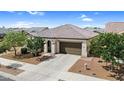 Single-story home with desert landscaping, a two-car garage, and a tile roof at 21104 E Poco Calle --, Queen Creek, AZ 85142