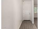 Clean, bright entryway with wood-look tile flooring and white door at 22040 N 119Th Dr, Sun City, AZ 85373