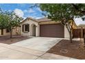 Charming home with a terracotta roof, desert landscaping and an attached two-car garage at 22040 N 119Th Dr, Sun City, AZ 85373