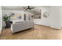 Bright living room with tile flooring, neutral decor, and a view into the dining area at 231 N 88Th Way, Mesa, AZ 85207