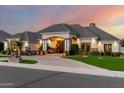 Beautiful home featuring manicured landscaping, a grand entrance, and tasteful exterior lighting at 23465 S 202Nd St, Queen Creek, AZ 85142
