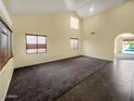 Bright living room with plush carpeting, a high ceiling, and natural light at 2521 N Franz Ln, Casa Grande, AZ 85122