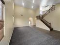 Spacious living area featuring plush carpeting, staircase, and an open layout at 2521 N Franz Ln, Casa Grande, AZ 85122