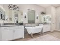 Elegant bathroom featuring a freestanding tub, dual vanities, and stylish fixtures, with a serene and luxurious design at 2605 S Quaintance St, Gilbert, AZ 85295