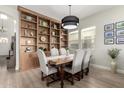 Inviting dining room featuring a large built-in bookcase, stylish furnishings, and ample natural light at 2605 S Quaintance St, Gilbert, AZ 85295