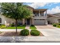Inviting home with stone accents, porch seating, and lush landscaping at 2605 S Quaintance St, Gilbert, AZ 85295