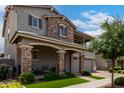 Charming two-story home with a stone facade and manicured lawn at 2605 S Quaintance St, Gilbert, AZ 85295